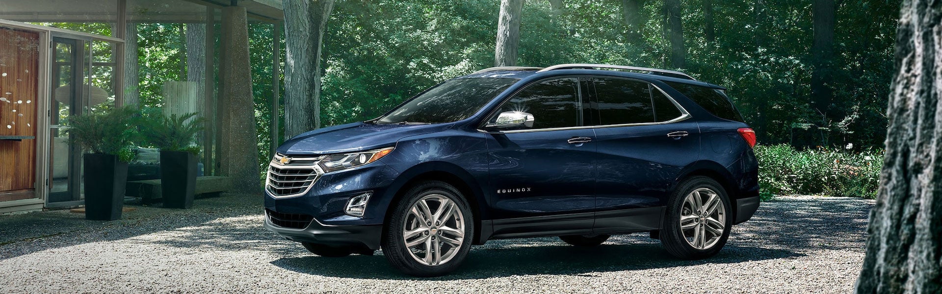2021 Chevrolet Equinox parked in a forest with a light shinning through