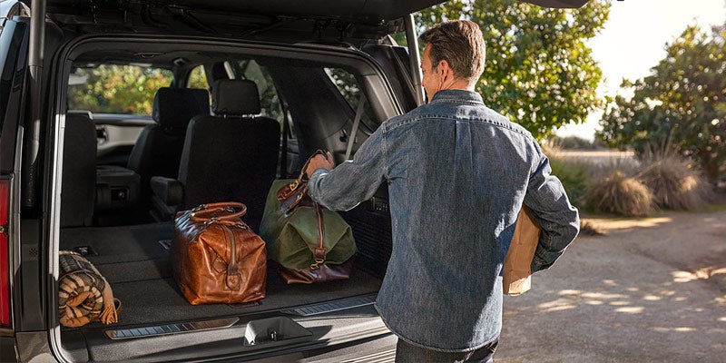 Man loading groceries in a 2021 Chevrolet Tahoe