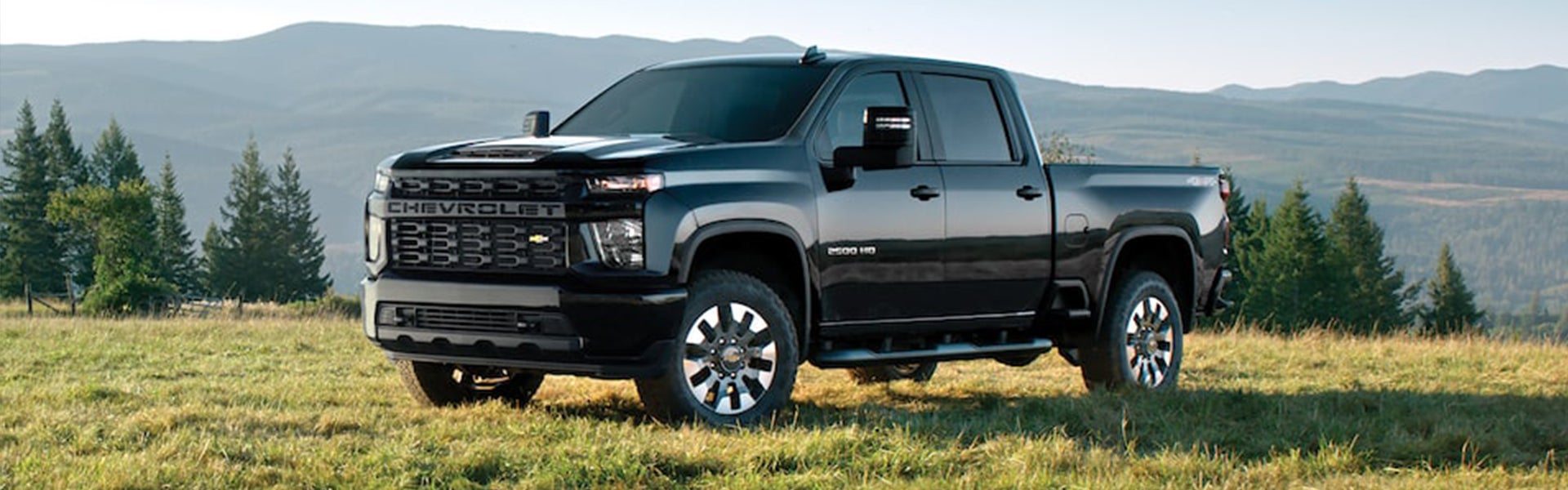 Black 2023 Chevrolet Silverado 2500HD sitting in a field