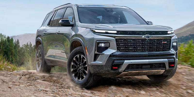 Silver 2025 Chevrolet Traverse parked on a hill