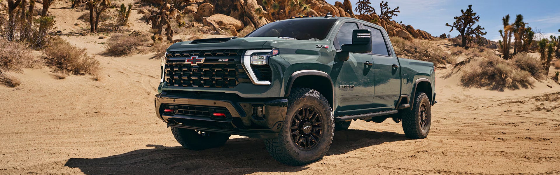 Dark green Chevrolet Silverado parked on a desert landscape