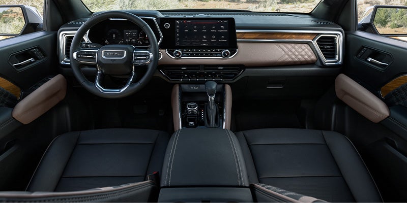 Interior of 2024 GMC Canyon beige and black with wood grain