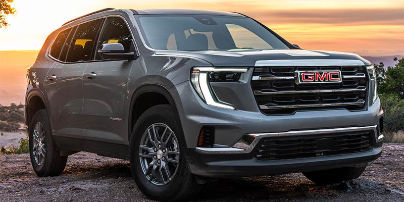 Silver 2025 GMC Acadia Parked In The Desert displaying front view