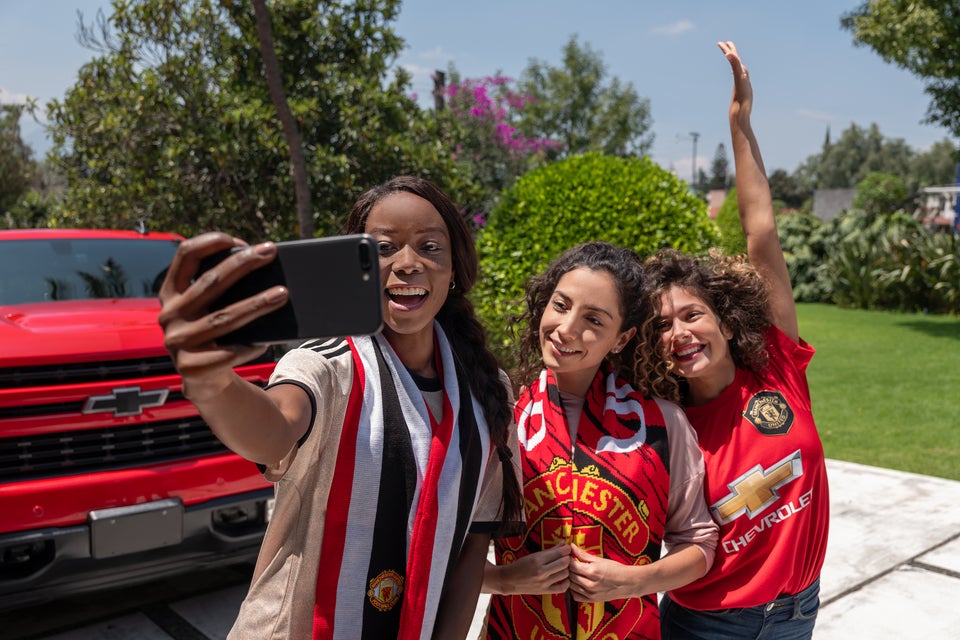 girls posing in front of Chevy truck