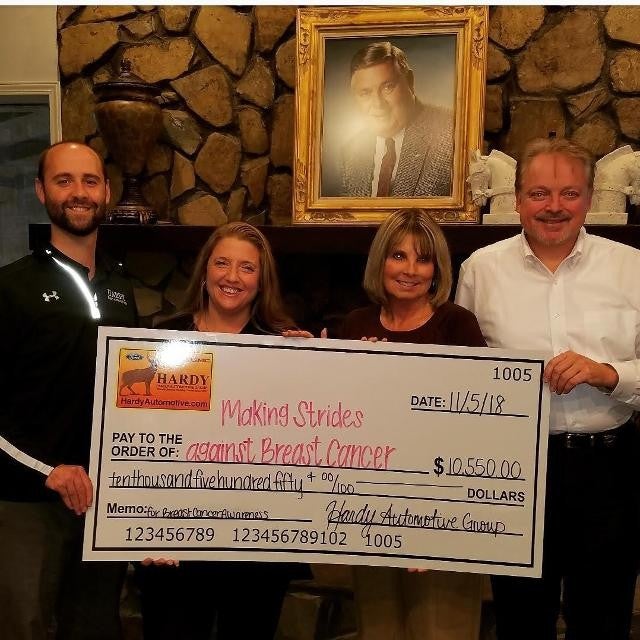 customer with their check to hardy for breast cancer