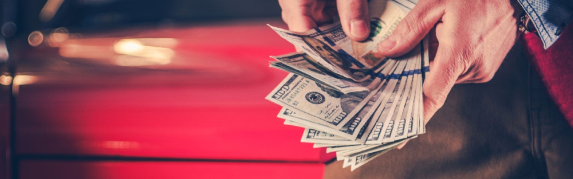 Hands flipping through a stack of US dollar bills